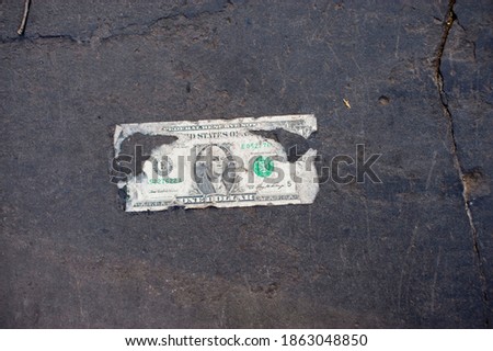 One dollar Bill or Money. Dollar Bill photographed on city street.