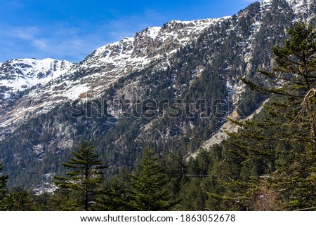 Peaceful nature view of Gaube Valley with amazing snow-capped mountain range background in the French Pyrenees, in the department of the Hautes-Pyrénées, near the town of Cauterets, France. 