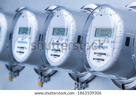Digital electric meters in a row measuring power use. Electricity consumption concept. 3d illustration Royalty-Free Stock Photo #1863109306