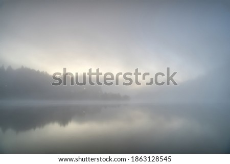 Foggy morning at a lake Royalty-Free Stock Photo #1863128545