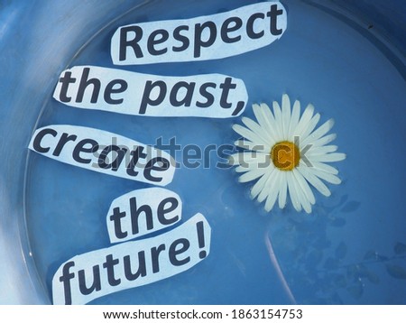 respect the past, create the future. paper cut letters on water.