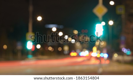 Defocused photography of traffic at the Moscow highway. Street is filled by cars. Bright blurred motion of cars at motorway in night time. Frontal and backs view