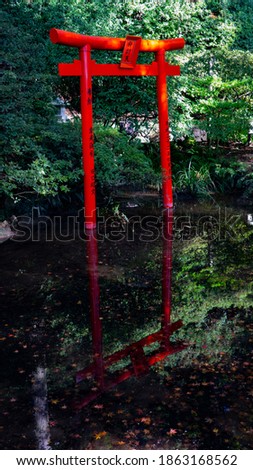the red Shinto shrine reflected on the water surface 
Japanese translation: the Goddess of Eloquence 