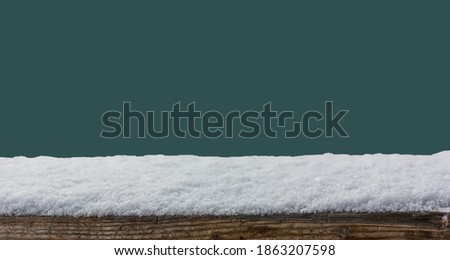 Empty wooden table snow covered  isolated on Tidewater Green color background