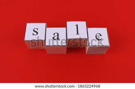 The inscription on a red background "sale" from wooden cubes. Black Friday, Christmas, discounts, and online shopping