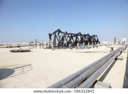 Black oil pump jacks in the desert of Bahrain, Middle East