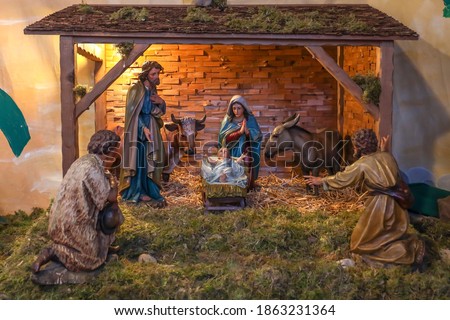 A model of the Traditional Nativity scene with holy family in Bethlehem and the baby Jesus lying in a manger at Christmas market. Royalty-Free Stock Photo #1863231364
