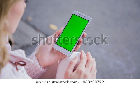 Women holding a phone in the park