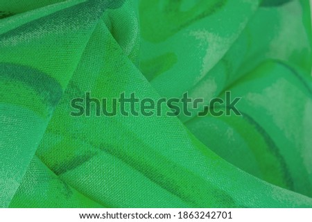 Texture, Pattern. Smooth elegant green fabric texture with abstract green print. luxury as abstract background. Luxury Christmas background. Fabric, delicate.