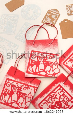 stamping with Christmas motifs made with stencil drawings. Template craft.