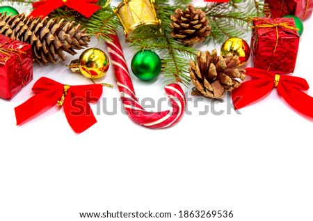 New year and Christmas background with Christmas candy, fir branches, cones and gifts on a white background