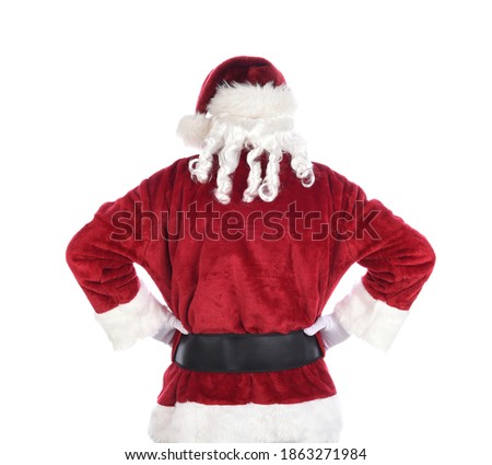 Santa Claus seen from behind standing akimbo with closed fists on hips. Isolated on white.