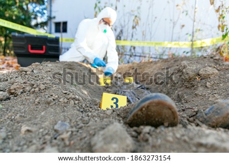 Crime scene investigation. Forensic science specialist at work. Royalty-Free Stock Photo #1863273154
