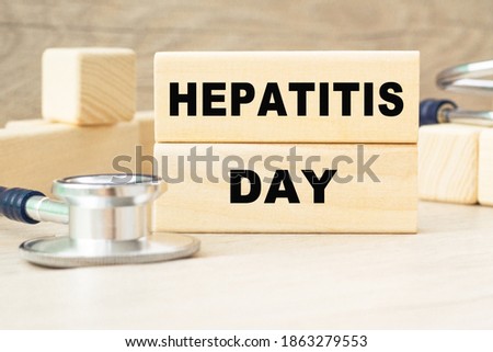 the word Hepatitis day is written on a wooden cubes structure . Cube on a bright background. Can be used for Medical concept. the medicine.