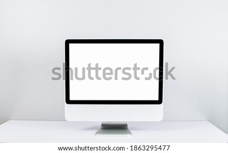  Computer monitor isolated on white screen on office style desk.