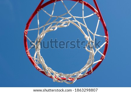 basketball basket against a blue sky, inside view