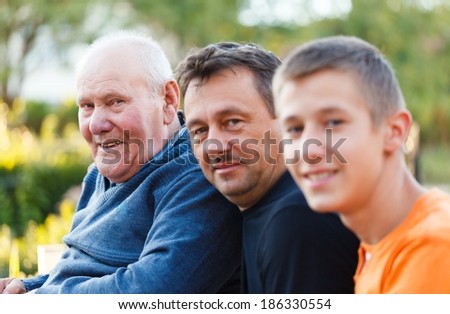 Portrait of three generations male family members together. Royalty-Free Stock Photo #186330554