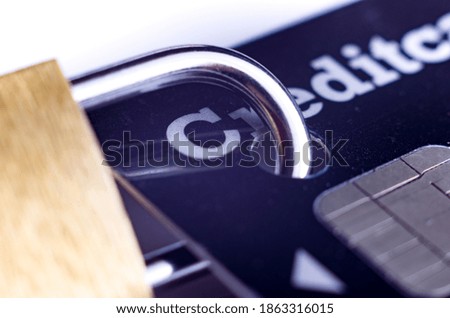 Macro photo padlock attached to credit card.