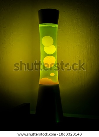 In this picture we see a green lava lamp that is in full swing.