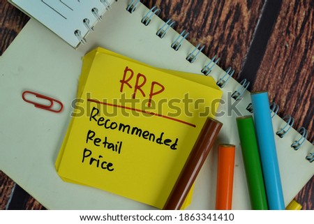 RRP - Recommended Retail Price write on sticky notes isolated on Wooden Table.