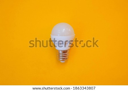 white led light bulb isolated on yellow background. concept Idea.