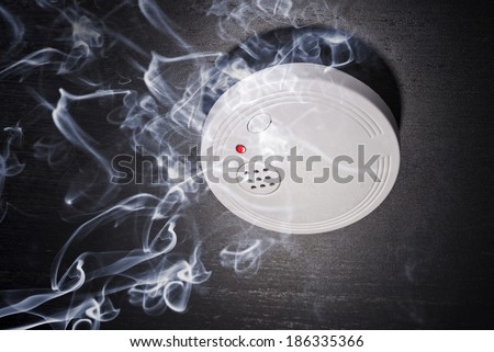 Smoke detector in the smoke of a fire Royalty-Free Stock Photo #186335366