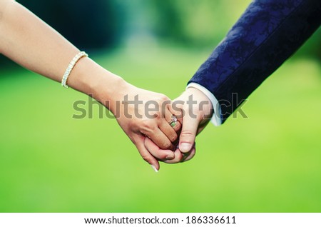 Bride and Groom Holding hands Royalty-Free Stock Photo #186336611