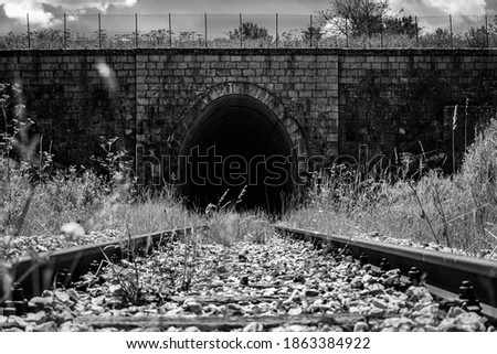 Rivisondoli, 21 august 2020 Italy, front view of a tunnel and in the foreground the train tracks and in the background the tunnel
