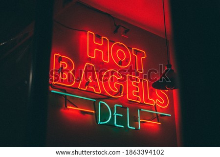 Hot Bagels Deli neon sign at night, in Manhattan, New York City