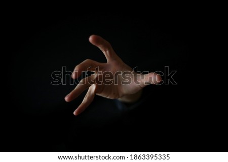 Image of an approaching male hand
