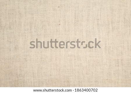 Burlap natural color fabric background.  It's a large area that is blank for space for copy, text, or your design element.  