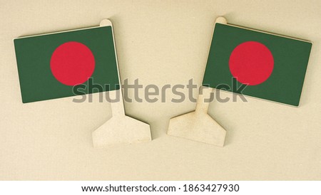 Flags of Bangladesh made of cardboard on the desk, flat layout