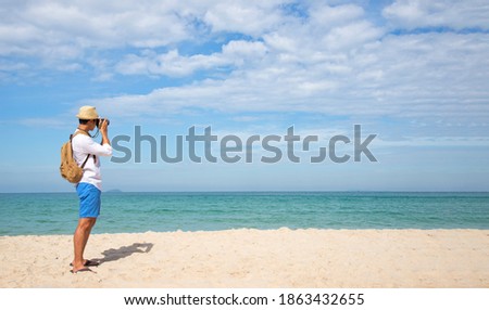 Happy lifestyle asian  man in sea beach, relax on the beach in summer. Travel Concept