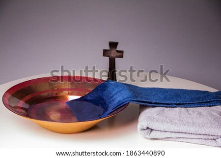 Towel in bowl of water on Maundy Thursday Royalty-Free Stock Photo #1863440890