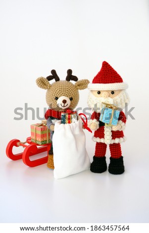 small and cute amigurumi. Santa Claus and reindeer