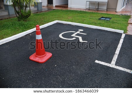 car parking road sign for disabled outdoors with a cone