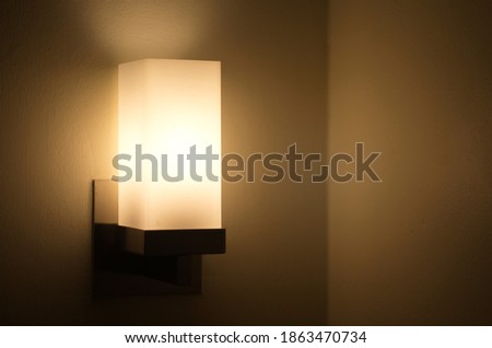 Sleeping head lamp. Lamp shines with light on the wall. Warm lighting.