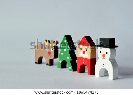 Christmas Themed wooden toys (Santa claus, Snowman, Reindeer and Christmas Tree) isolated on white background with space for text.