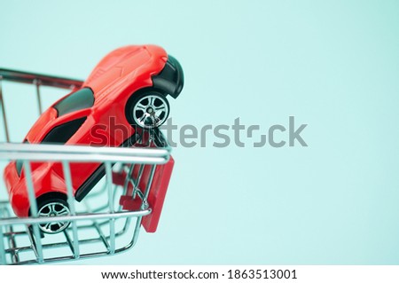 the red car trolley for shopping, the concept of buying a car