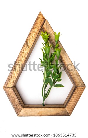 wooden wall decorative  frame in the shape of a pentagon with an artificial flower in the center. on a white isolated background.