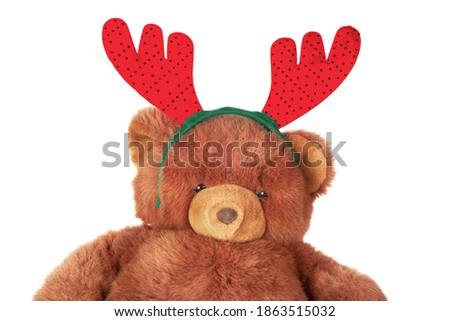 Teddy bear in christmas deer hat, isolated on white background.