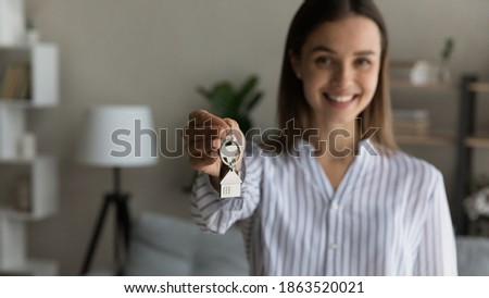 Crop close up wide banner panoramic view of female renter or tenant show keys to new home or apartment. Woman buyer or owner feel excited buy first own house. Real estate, rental, ownership concept.