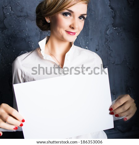 Businesswoman holding a white poster and smiling. Photo in color style instagram filters
