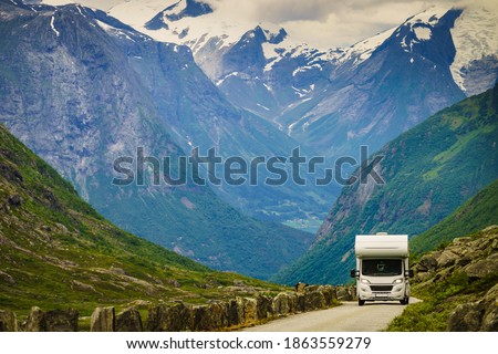 Mountains landscape and camper car on national tourist scenic route Gamle Strynefjellsvegen. Travel in motor home and adventure. Royalty-Free Stock Photo #1863559279