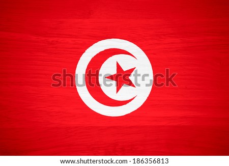 Tunisia flag on wood texture