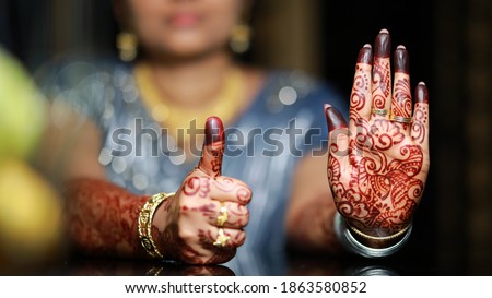 Close up shot of Indian female hand with mehndi design on traditional kerala hindu wedding 
