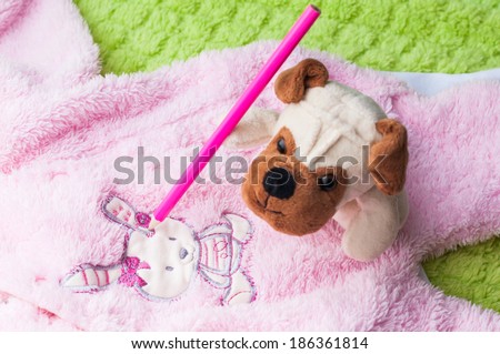 Plush puppy painting little bunny on baby sleepsuits.