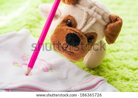 Plush puppy painting little bunny on baby sleepsuits.