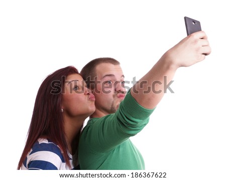 young people making silly duck face while taking a self portrait with smart phone