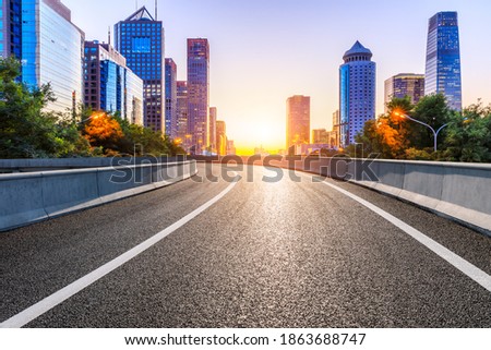 Empty asphalt road and modern cityscape in Beijing at sunset,China.
